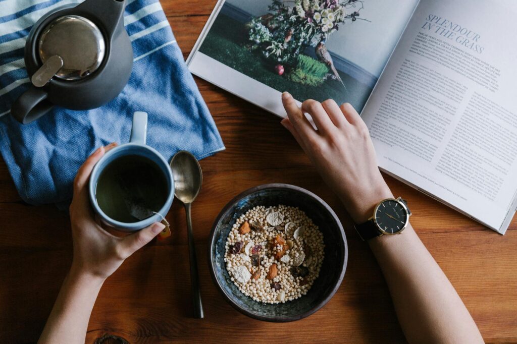 person holding white ceramic coffee cup leaning on brown wooden table- depression diet