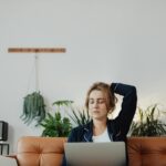 woman sitting on a sofa with a laptop