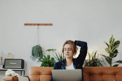 woman sitting on a sofa with a laptop