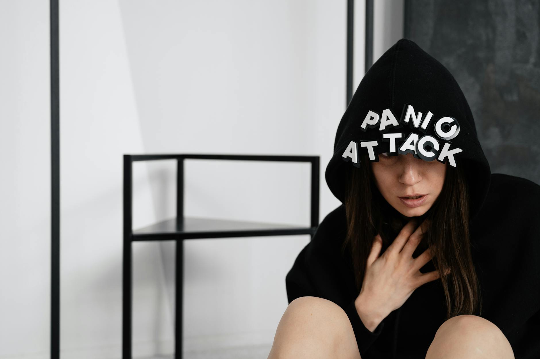 woman in black hoodie with panic attack